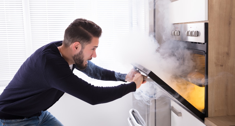 Man surprised by smoke pouring out of oven